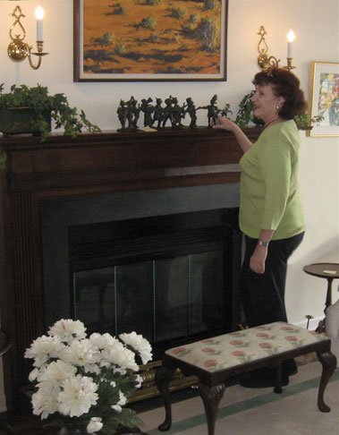 Katie cleaning the fireplace mantle